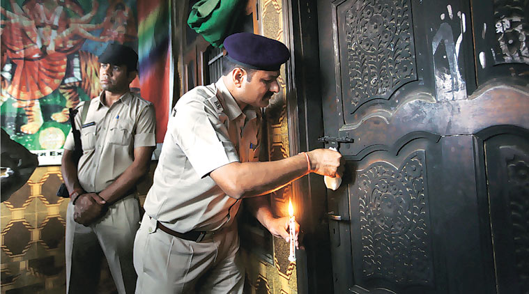 A policeman seals the room where the attack took place in Sunpedh. (Source: Express photo by Oinam Anand)