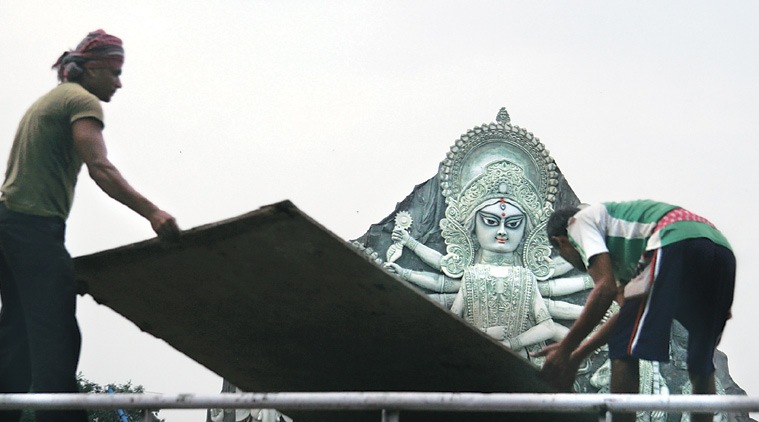 Workers dismantle the puja pandal at Deshapriya Park in Kolkata on Wednesday. (Source: Express photo by Partha Paul)