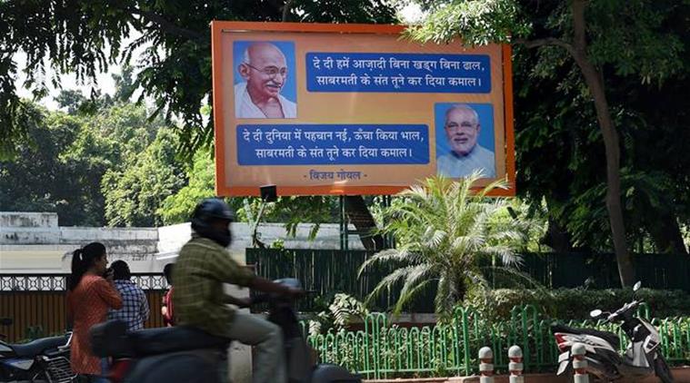 New Delhi: A bill board put up by BJP MP Vijay Goel at his residence presents Prime Minister Narendra Modi as "Sabarmati ka Sant" like Mahatma Gandhi in New Delhi on Thursday. PTI Photo by Manvender Vashist  (PTI10_1_2015_000069B)