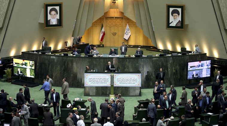 In this photo taken on Sunday, Oct. 11, 2015, head of Iran's Atomic Energy Organization Ali Akbar Salehi, center, ends his speech in an open session of parliament while discussing a bill on Iran's nuclear deal with world powers, in Tehran, Iran. Iran's parliament voted Tuesday to support implementing a landmark nuclear deal struck with world powers despite hard-line attempts to derail the bill, suggesting the historic accord will be carried out. (AP Photo/Ebrahim Noroozi)
