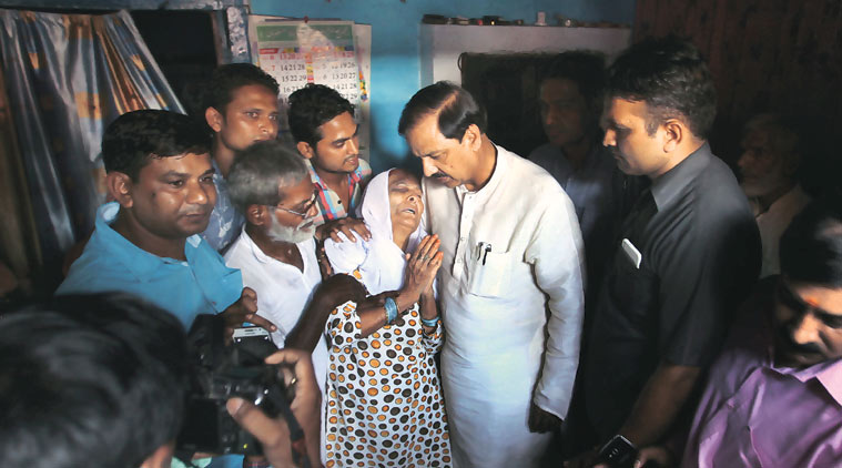 Union Minister and BJP MP from Noida Mahesh Sharma with Akhlaq’s family in Dadri Friday. (Source: Express Photo by Oinam Anand)