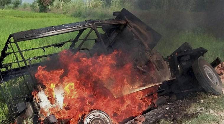 Mainpuri: A vehicle burns after villagers vandalised properties and resorted to arson in Mainpuri district on Friday over rumours of cow slaughter in the area. PTI Photo (PTI10_9_2015_000286A)
