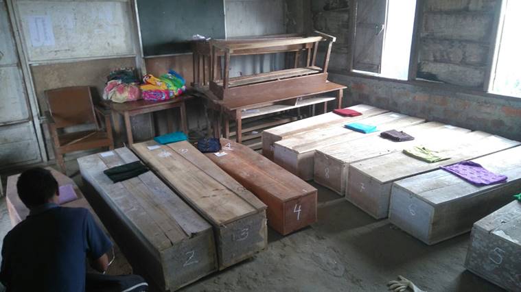 Coffins are laid out in a village building. At least 10 people died in the accident. Express Photo/Adam Halliday