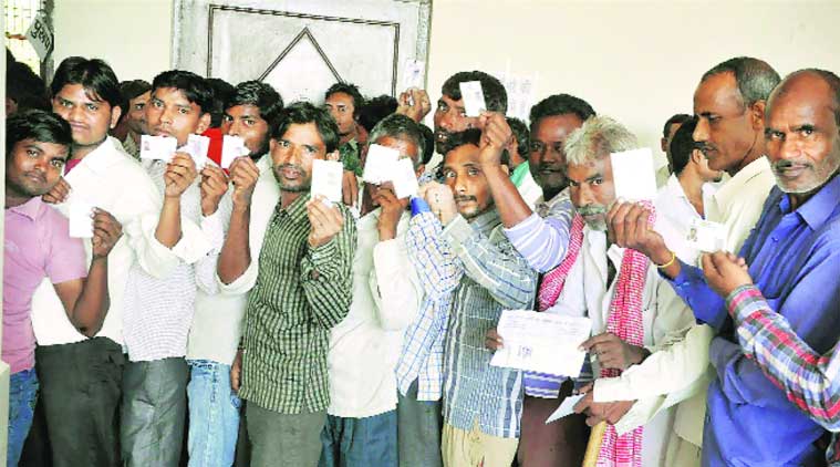Voters wait in a queue to exercise their franchise at a polling booth in Mathura on Saturday. (PTI )