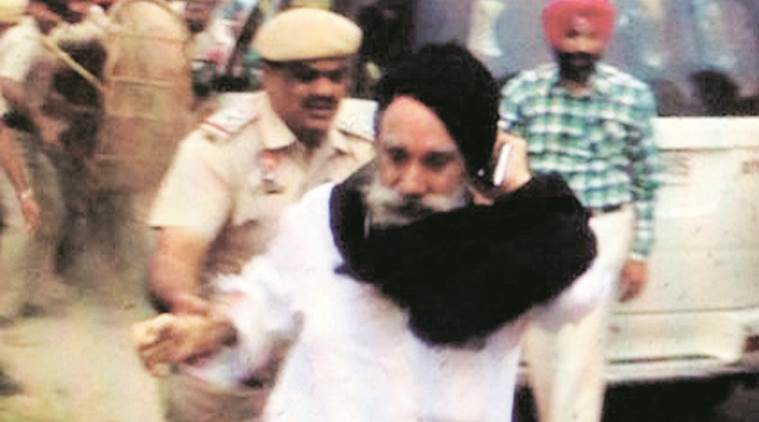 SGPC member Paramjit Singh Raipur flees from Sikh protesters at Adampur near Jalandhar on Sunday. Express