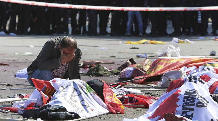 A man cries over the body of a victim, at the site of an explosion in Ankara, Turkey, Saturday, Oct. 10, 2015. The two bomb explosions targeting a peace rally in the capital Ankara has killed dozens of people and injured scores of others. The explosions occurred minutes apart near Ankara's main train station as people were gathering for the rally, organized by the country's public sector workers' trade union and other civic society groups. The rally aimed to call for an end to the renewed violence between Kurdish rebels and Turkish security forces. (AP Photo/Burhan Ozbilici)