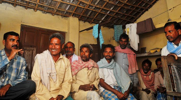 Sunil Sahni (left) alongwith other villagers of thier Nishad (Sahni)caste holds a discussion for the assembly election in Dumri in Muzaffarpur. Express Photo By Prashant Ravi
