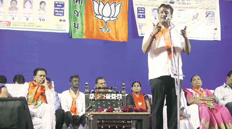 Jamalpur-Khadia BJP MLA Bhushan Bhatt (right) at a poll meet at Raikhad in Ahmeda-bad on Wednesday night. (Source: Express Photo by Javed Raja)