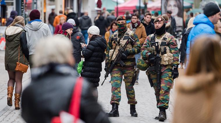 Soldiers from the Belgian army patrol in the picturesque Grand Place in Brussels on Friday, Nov. 20, 2015. Salah Abdeslam, a French national who lived in Molenbeek, Belgium, is currently the subject of an international manhunt after the Paris attacks. Security has been stepped up in parts of Belgium as a precaution. (AP Photo/Geert Vanden Wijngaert)