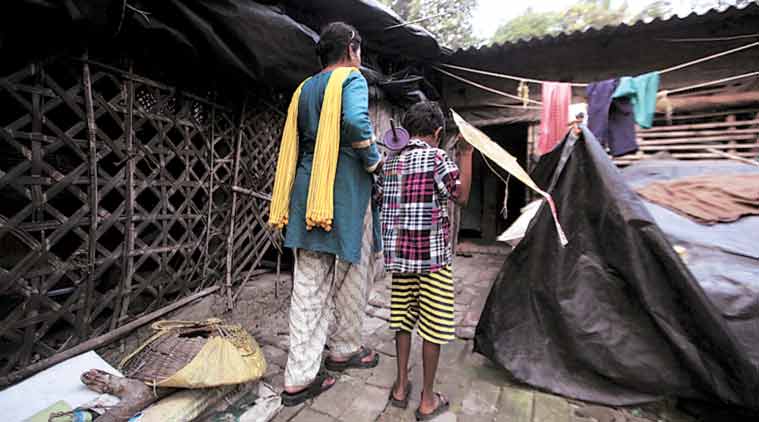 The boy, his mother at their home in Bishnupur in South 24 Parganas. (Express Photo by: Subham Dutta)