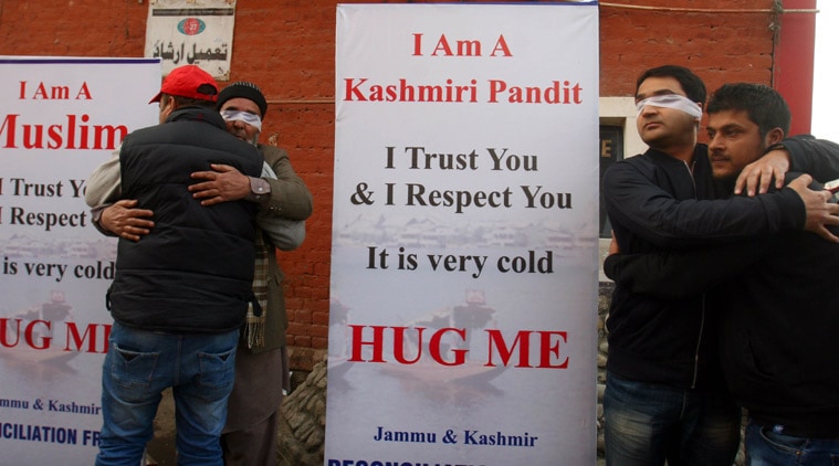 People hug each other during mega 'Hug Campaign' to promote universal brotherhood, interfaith dialogue, tolerance and bridge the gap between people of different communities within the state of J&K organised by Jammu and Kashmir Reconciliation front, in Srinagar on Monday. (Source: Express photo by Shoaib Masoodi)