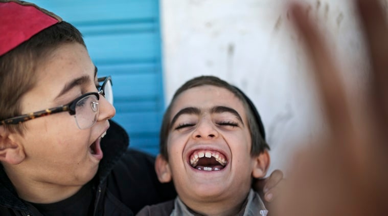 In this Friday, Oct. 30, 2015 photo, boys play outside their school at Hara Kbira, the main Jewish neighborhood on the Island of Djerba, southern Tunisia. (AP Photo/Mosa'ab Elshamy)