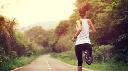 young fitness woman runner  running at forest trail