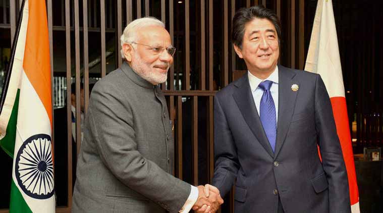 Prime Minister Narendra Modi shakes hands with his Japanese counterpart Shinzo Abe at a meeting in Kuala Lumpur. (Source: PTI)
