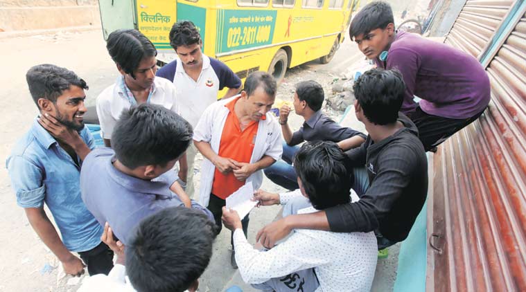  Harish Singh tries to convince migrant workers at the Govandi slum to get themselves tested (Express Photo by  Narendra Vaskar)