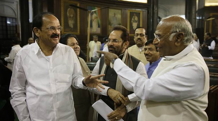 Indian Congress party member of Parliament Mallikarjun Kharge, right, talks to Bharatiya Janata Party leader and parliamentary affairs minister Venkaiah Naidu, left, at the central hall of Indian parliament house, in New Delhi, India, Friday, Nov. 27, 2015. (AP Photo/ Manish Swarup)