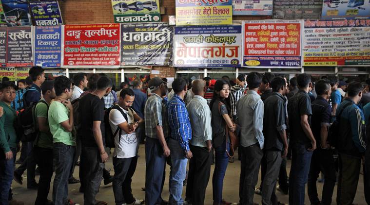 In this Tuesday, Oct. 13, 2015 photo, Nepalese people stand in a queue for bus tickets to travel home, with most of the country's bus services cancelled because of fuel shortage, in Kathmandu, Nepal. Tuesday marked the beginning of the two-week Dasain festival, a time when Nepalis travel to their home villages to be with family. Just when Nepal was recovering from the devastating earthquake that killed thousands, flattened hundreds of thousands of houses and chased away foreign tourists, protests by ethnic groups and severe fuel shortages are again keeping visitors away from the nation known for highest peaks in the world. (AP Photo/Niranjan Shrestha)