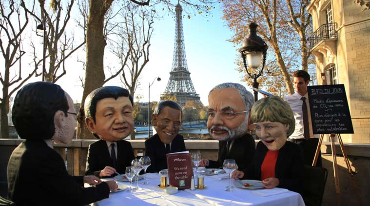 Activists wear masks depicting world leaders, including Prime Minister Narendra Modi, in Paris on Saturday. (AP Photo)