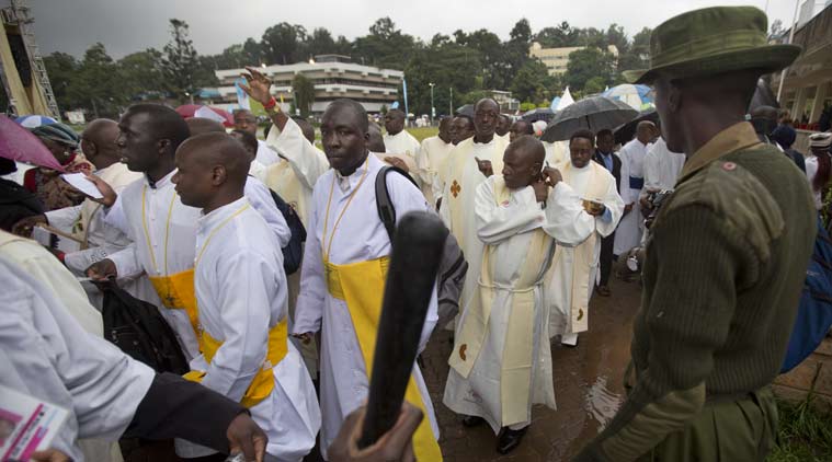 A Kenyan soldier directs Catholic priests as they queue after dawn to attend a Holy Mass to be given by Pope Francis at the campus of the University of Nairobi in Kenya. (Source: AP)