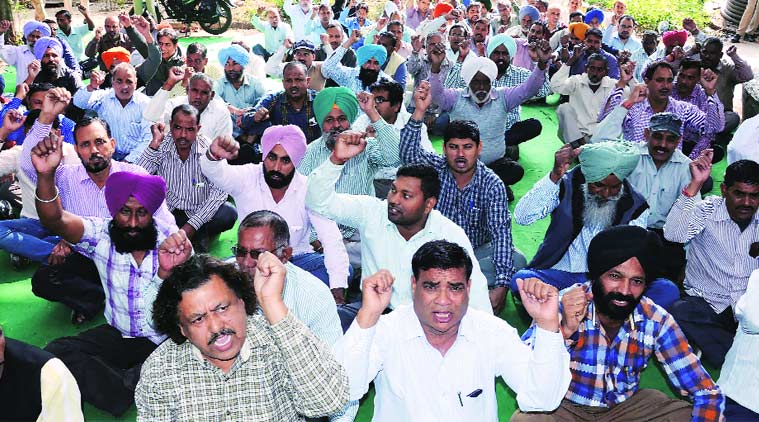 Employees protest outside the electricity department office in Sector 18, Chandigarh, on Thursday. (Express photo)