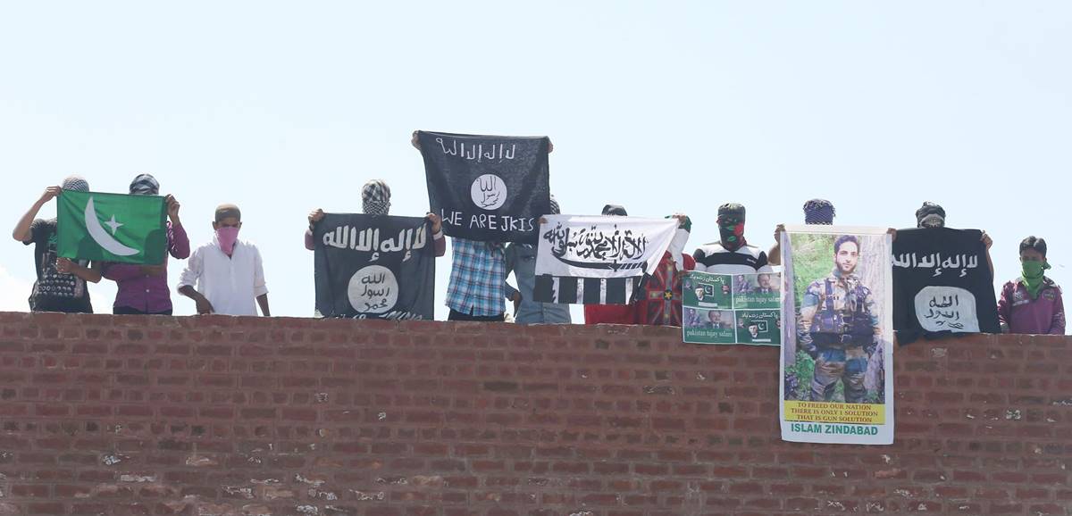 Masked Kashmiri youth hold Islamic State and Lashkar-e-Taiba flags as well as posters of Pakistan founder Ali Mohammad Jinnah during protest outside Jamia Masjid in Srinagar. Express Photo