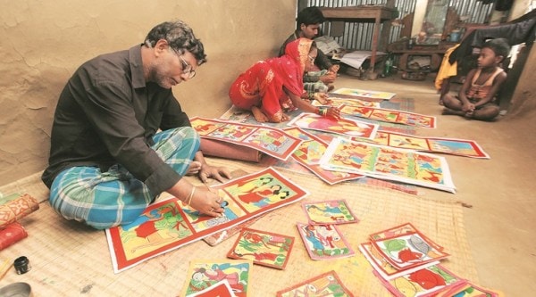 Yakub Chitrakar painting scroll along with his family members at his home at Noya in West Midnapore. (Source: Express photo by Subham Dutta)