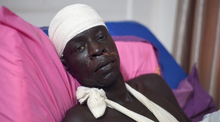 Wuor Arop, one of two survivors of the cargo plane crash which killed at least 37 people Wednesday, lies in a hospital bed in the South Sudan capital Juba on Saturday, Nov. 7, 2015. Arop, who cradled the other survivor, a 13-month old baby who suffered a broken leg and a cut forehead, and is recovering with bones broken in six places and a head injury. Arop said the plane, which was not authorized to transport passengers, carried up to 40 people on board at the time of the crash. (AP Photo/Jason Patinkin)