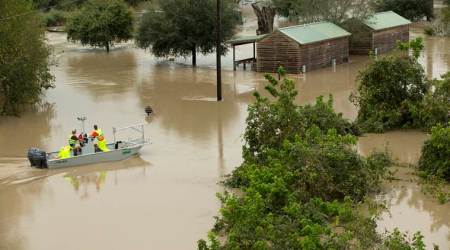 Workers with the U.S. Geological Survey look at the flooding at the Bastop, Texas KOA Campground on Saturday, Oct. 31, 2015. Storms and suspected tornadoes hit an already-sodden swath of the state that was still drying out from the remnants of Hurricane Patricia. (Jay Janner/Austin American-Statesman - statesman.com via AP)