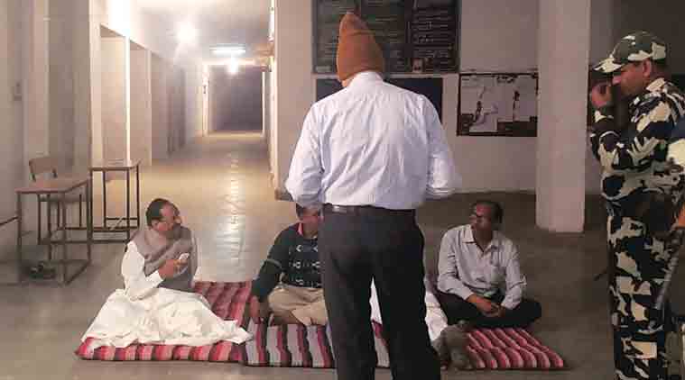 Kantilal Bhuria outside the strong room at Government Polytechnic in Jhabua, where EVMs have been kept. (Express Photo)