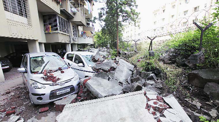 Damaged cars at Gagan Vihar Society, near Market Yard, after the society wall collapsed due to heavy downpour on Sunday night. (Pavan Khengre)