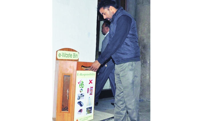 A city resident uses an  e-waste bin at the UT Secretariat in Sector 9, Friday.  Sahil Walia