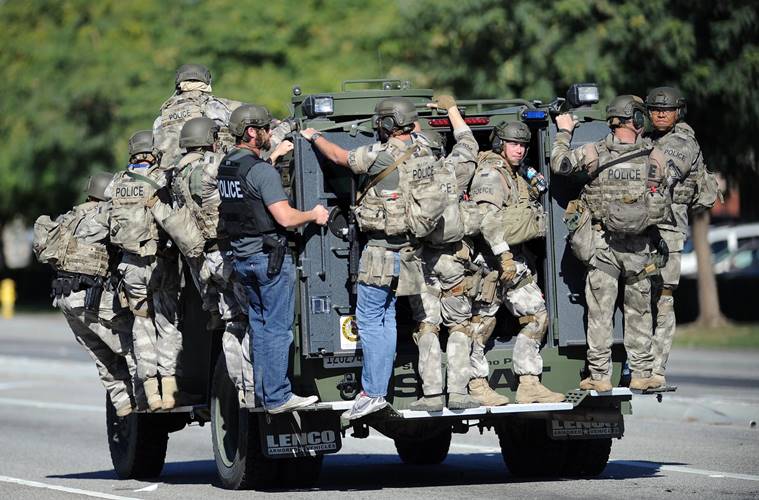 A SWAT vehicle carries police officers near the scene of a shooting in San Bernardino, California. (Micah Escamilla/Los Angeles News Group via AP)