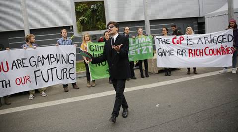 Activists hold banners at the COP21, the United Nations Climate Change Conference Tuesday, Dec. 1, 2015 in Le Bourget, north of Paris. A dozen activists unfurled banners and performed a skit outside the exhibition halls hosting high-stakes climate talks through Dec. 11. (AP Photo/Christophe Ena)