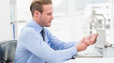 Businessman suffering from wrist pain