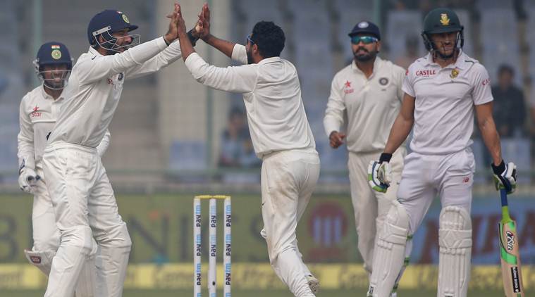 Indian team members celebrate the wicket of South Africa's Faf du Plessis, on the last day of their fourth and final test cricket match in New Delhi, India, Monday, Dec. 7, 2015. (AP Photo/Tsering Topgyal)