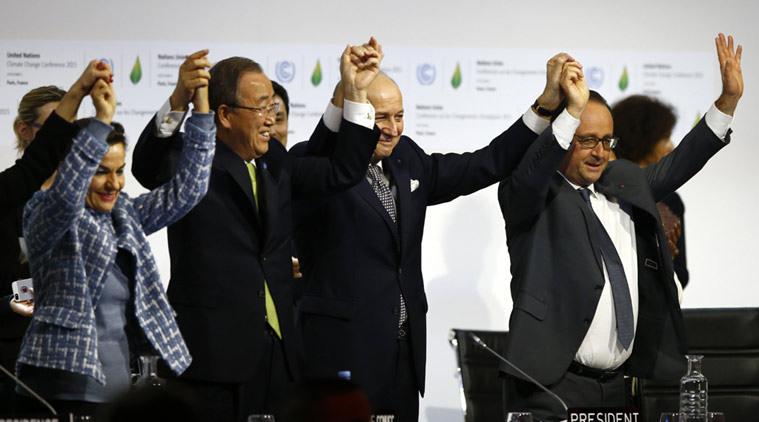 French President Francois Hollande, right, French Foreign Minister and president of the COP21 Laurent Fabius, second, right, United Nations climate chief Christiana Figueres and United Nations Secretary General Ban ki-Moon hold their hands up after the final conference at the COP21, the United Nations conference on climate change, in Le Bourget, north of Paris, Saturday, Dec.12, 2015. (Source: AP)