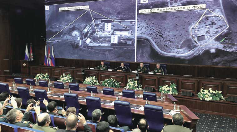Top Russian military officials display, to reporters in Moscow on Wednesday, satellite images of alleged oil trucks at the Syria-Turkey border. (Source: AP)