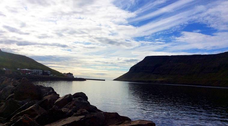 This Aug. 8, 2015 photo shows an imposing headland marking the head of the fjord leading to Sudureyri, Iceland. The fishing village has only about 500 people, but plays host to a summer theater festival popular among language students innearby Isafjordur. (AP Photo/Jim Heintz)