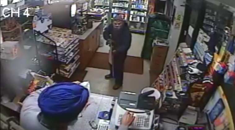 Amrik Singh is seen as a masked gunman tries to rob him at his petrol station in Staatsburg, near New York City, in a still from a surveillance video. (Credit: Youtube/NYSP PIO)