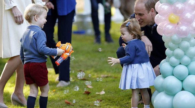 Britain's Prince William and Princess Charlotte look on as Prince George plays with a bubble gun at a children's party at Government House in Victoria. (File/AP)