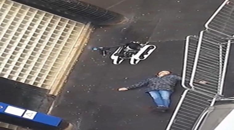 In this image taken from a validated UGC video the body of man lies on the ground near a police robotic device after the he was shot dead by officers at a police station in northern Paris. Thursday, Jan. 7, 2016. Tensions in France, under a state of emergency since a wave of attacks on Nov. 13, have been even higher this week as the anniversary of the January attacks approached. (AP Photo)