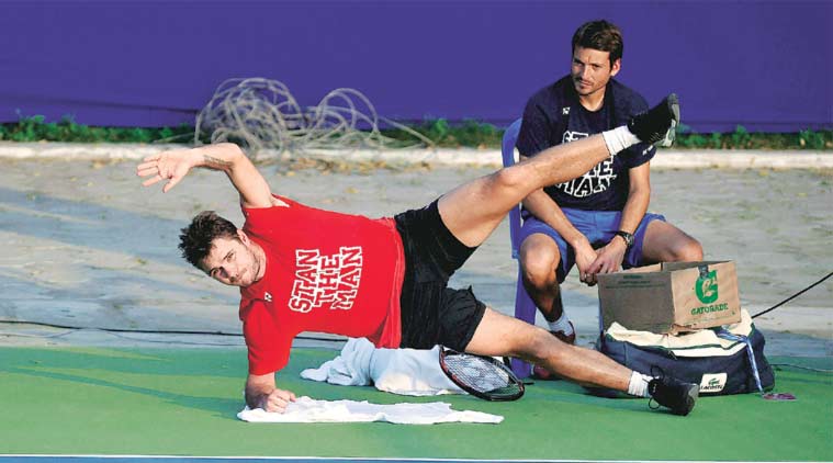 Two-time defending champion Stanislas Wawrinka of Switzerland stretches during a practice session on Monday. He will feature in the doubles draw on Tuesday. (Source: PTI)