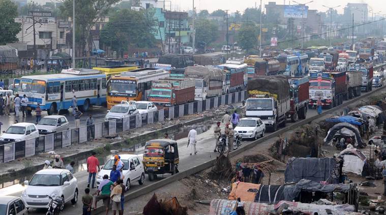 Commuters harassed as While demanding screening of the movie MSG-2 in punjab, Protesting Dera supporters blocks the Ludhiana-Delhi National Highway at Dhandari Kalan in Ludhiana. Express Photo by Gurmeet Singh. 20.09.2015.