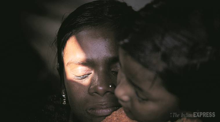 Bahaduri with a child from the neighbourhood after she lost her children. Express Photo/Oinam Anand