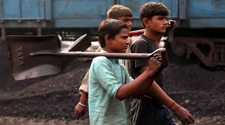 Child labourers going back to home after finishing their work at the Katra railway station to unload the coal from the train in Gonda (UP) on Nov 11th 2012. Express photo by RAVI KANOJIA.