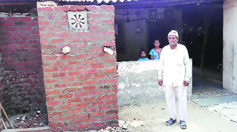 Bhikhabhai Senma shows one of the under construction toilets. Express photo