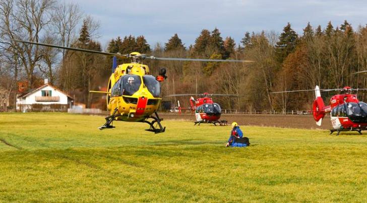 Helicopters of rescue services are seen at a field near Bad Aibling in southwestern Germany, February 9, 2016. About eight people were seriously injured and 12 more slightly hurt in a train crash in the southern state of Bavaria on Tuesday, German police said. REUTERS/Michael Dalder