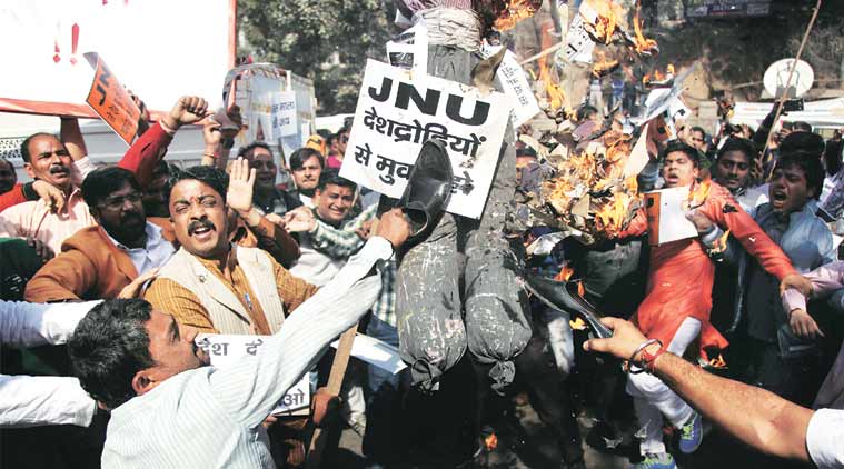 Activists of Bajrang Dal and Vishwa Hindu Parishad organise a protest outside JNU Tuesday, shouting slogans and burning effigies of the JNU Vice-Chancellor. (Express Photo Tashi Tobgyal)