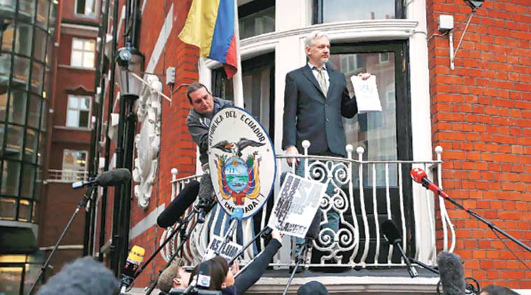 Assange holds a copy of the UN ruling at the Ecuadorian embassy in London. (Source: Reuters)