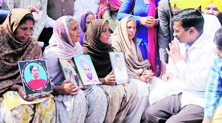 Kejriwal with wives of farmers who committed suicide, in Sangrur Thursday. (Express Photo: Gurmeet Singh)